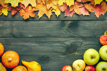 Canvas Print - Autumn leaves, apples and pumpkins over wooden background