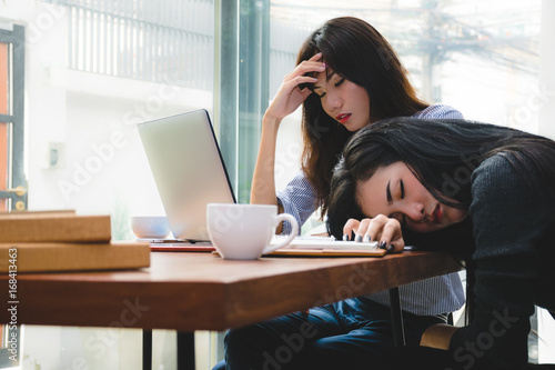 Tired Young Asian Businesswomen Falling Asleep On The Desk In