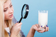 © anetlanda - Woman looking at milk through magnifying glass