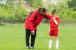 © Dusan Kostic - Kids soccer football - coach comfort little soccer player after a missed goal