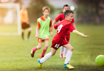 Wall Mural - Kids soccer football - children players match on soccer field