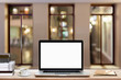 © redkphotohobby - Blank screen laptop, coffee cup, books and notebook on wood table with night view background.