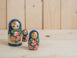 Wall Mural - Travel around the world for your colorful life .Enjoy the funny trip journey .Top view for copy space some idea your create destination .object  cute  ,  Set of matrioshka dolls on pine wood.