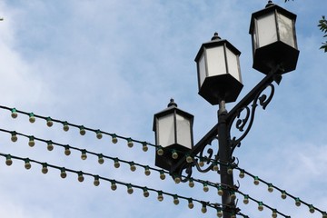 Sky, clouds, electricity, street lights, light bulbs, wires, trees, lantern, street, city, cityscape, light, bulb, architecture, design,