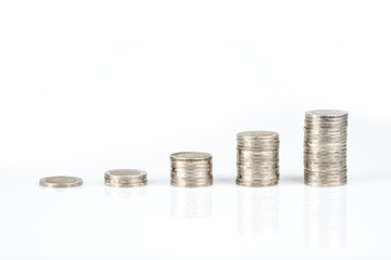 Savings, business growth, financial stability concept by several stacks of coins on white background.