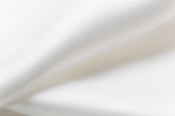 close up of folded shiny white fabric