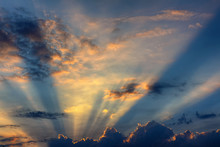 Sunset, The Sun Behind The Clouds With Rays Of Light In The Evening During A Solar Eclipse
