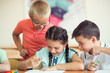 © spass - Group of school children learning at klassroom in school