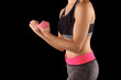 © Lovrencg - Woman lifting weights while doing aerobics.