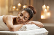 © Cookie Studio - Beautiful african girl resting relaxing in spa resort with closed eyes.