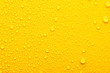 Leinwandbild Motiv water drops on a yellow background