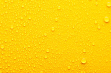 Water Drops On A Yellow Background