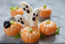 Healthy Fruit Halloween Treats. Banana Ghosts And Clementine Orange Pumpkins
