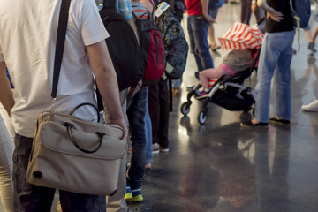 Closeup Queue of Europen people waiting at boarding gate at airport