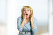© DenisProduction.com - Surprise astonished middle aged woman. Close up portrait of white-skin woman looking surprised in full disbelief with open mouth and raised hands.