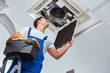 © Elnur - Worker repairing ceiling air conditioning unit