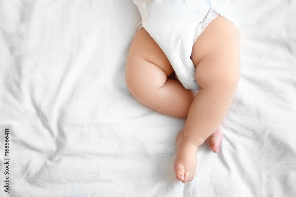 Cute little baby sleeping on bed at home