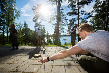 Wall Mural - Man Picking Wooden Block With Rope While Playing With Friends