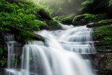 Fototapeta Krajobraz - Waterfall hidden in the tropical jungle