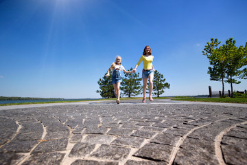 Wall Mural - Beautiful sisters girl on the meadow