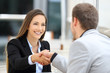 © Antonioguillem - Executives handshaking in a coffee shop