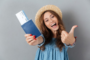 Sticker - Woman standing over grey wal holding passport and ticket