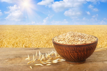 Wall Mural - ears of oats and oat grains in bowl