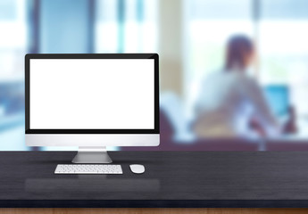 Wall Mural - blank screen desktop computer on black board wooden table top with blur people working at office des