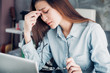 © weedezign - Stressed Asian creative designer woman cover her face with hand and feel upset from work in front of laptop computer on desk at office,Stress office lifestyle concept.