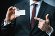 © LIGHTFIELD STUDIOS - businessman pointing at business card