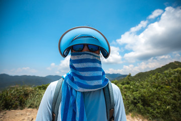 Girl DIY sunblock protect while hiking 