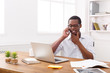 © Prostock-studio - Young black businessman talking on mobile in modern white office