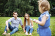 © Artem - Young happy family in summer Park