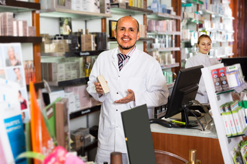 Wall Mural - ﻿pharmacists standing with a cash desk