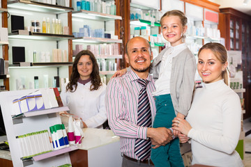 Wall Mural - Family with a kid in pharmacy .