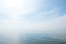 Calm Tranquil Blue Sea With No Waves And With Foggy Backgroudn