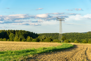 power line in the evening in front of a cloudy sky