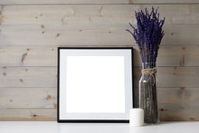 Close Up Picture Of Foursquare Space Photo Frame With Copy Space, White Paraffin Candle And Glass Vase With Dried Lavender Flowers In It. Ideas For Interior, Decor, Decoration And Design Concept