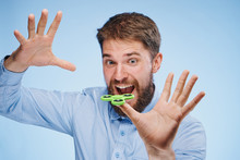 Man With A Beard On A Light Blue Background Holds A Green Spinner