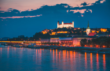 Wall Mural - Castle of Bratislava, Slovakia at Night as Seen from a Bridge over Danube River Towards Old Town of Bratislava.