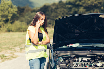 Woman calling for help because her car broke down on the highway