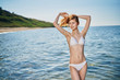 © SHOTPRIME STUDIO - Woman in a white bathing suit on the beach of the sea, summer, vacation, sun