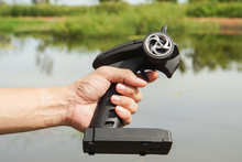 Close Up Man Hold Speed Boat Remote Control For Playing