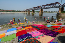 Washing Clothes On The River Bank