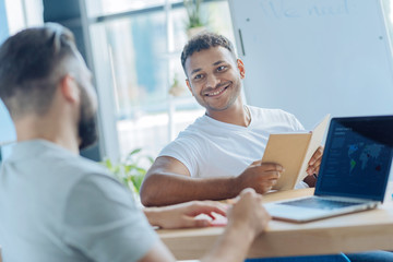 Wall Mural - Handsome cheerful man looking at his colleague