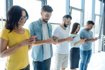 Wall Mural - Cheerful young people using social networks