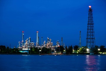 Oil refinery plant near river at twilight, Business and  Industry concept