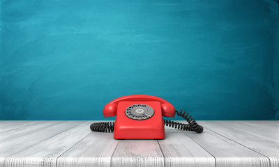 Wall Mural - 3d rendering of a bright red dial phone standing on a wooden desk and a blue wall background.