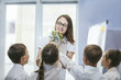 © kuzmichstudio - Beautiful children school children with flowers for the teachers at school