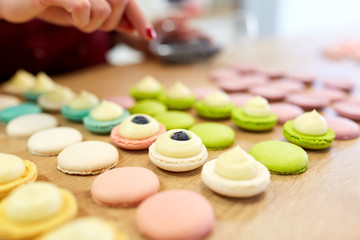 Wall Mural - chef decorating macarons shells at pastry shop